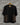 Floral embroidery on black pashmina tshirt displayed against grey brick wall 
